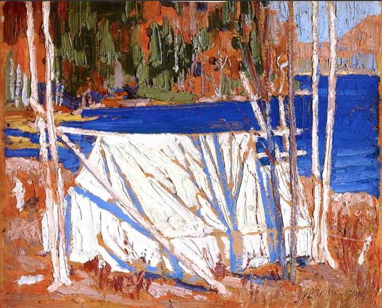 13 – The Tent by Tom Thomson oil painting of white tent slung between silver birch trees at the edge of a wooded shoreline of bright blue water