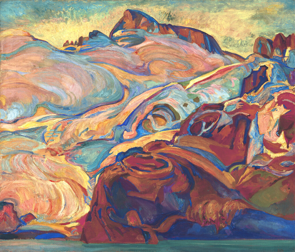 Oil painting of mountains in bright and pastel shades of blue, yellow, red, green, orange. A narrow band of blue water at the bottom of the painting and blue sky with clouds at the top.