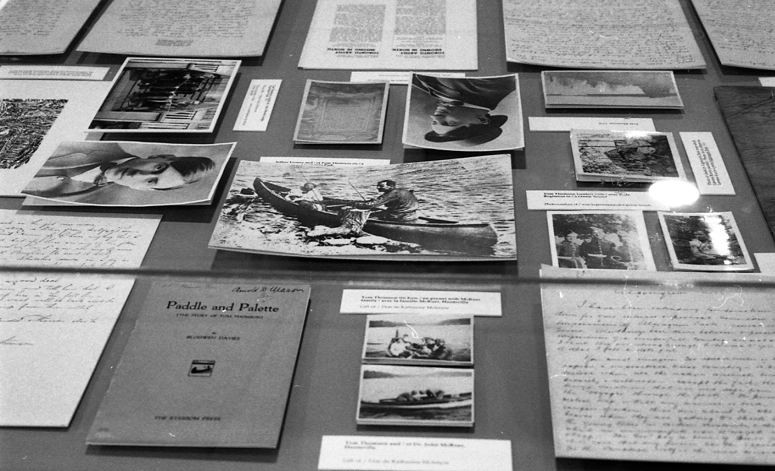 black and white photograph of documents, letters and books on a table